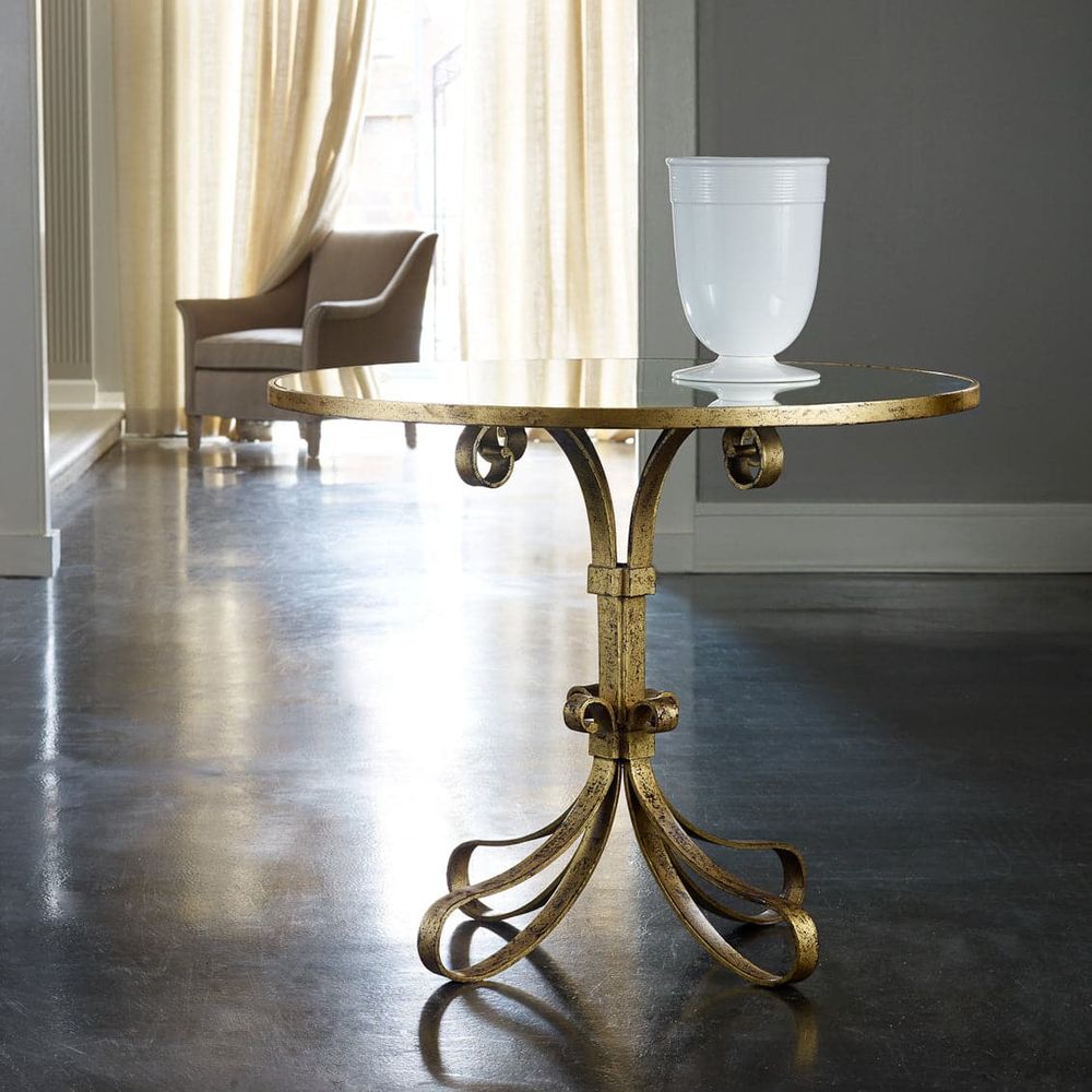 Provence Center Table, shown in antique gold and clear with glass, wrought metal, and a round glass top surface.