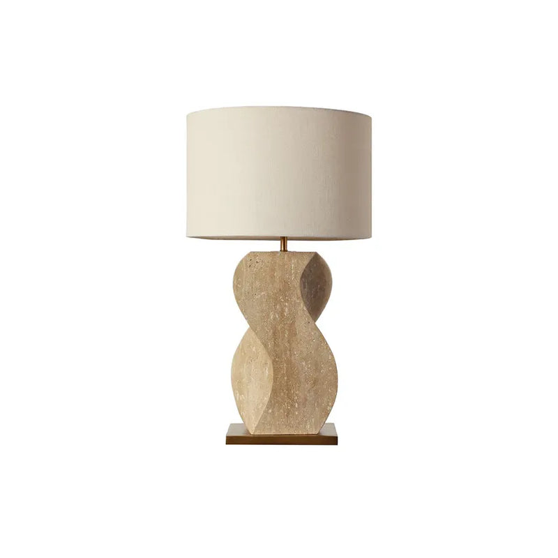 Anusha Table Lamp, shown in beige and ivory with travertine, fabric, and a fabric drum shade.