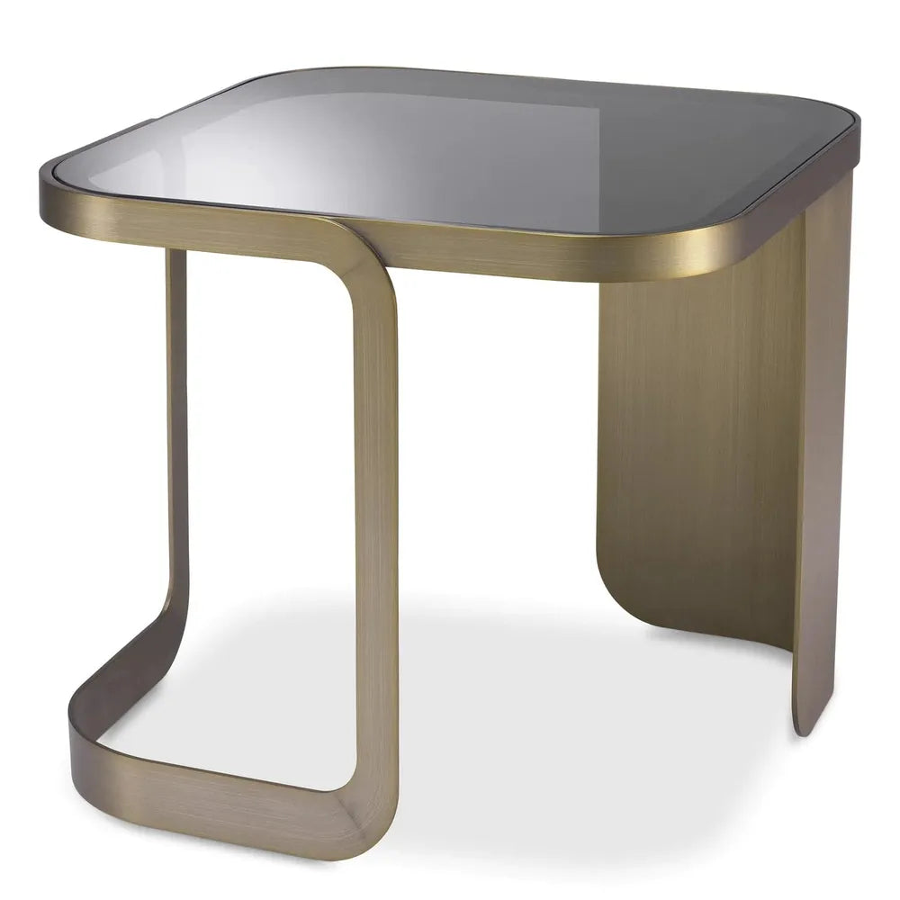 Side Table Numa, shown in brushed antique brass and smoked gray with metal, glass, and fixed asymmetric base.