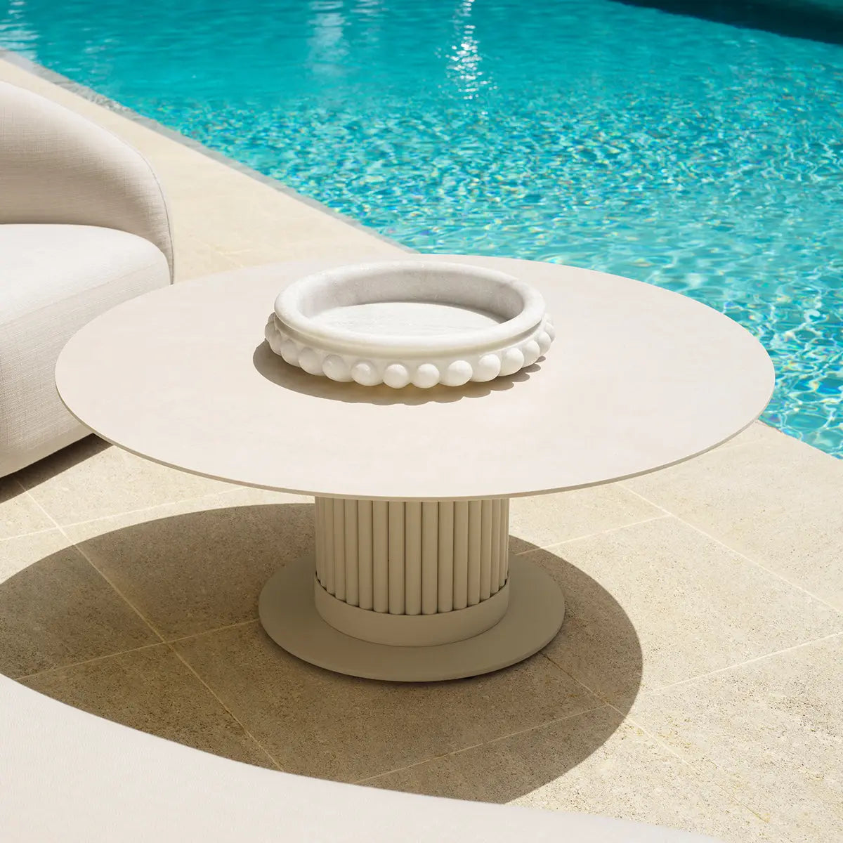 Alternate view of Outdoor Coffee Table Volterra Round Sand Finish Cream Ceramic in cream and sand beige.