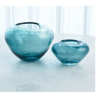 Undulating Vase, shown in teal and aqua blue with glass and open top vessel.