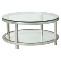 Per Se Round Cocktail Table, shown in silver and clear with metal, glass, and two-tier circular glass shelves.