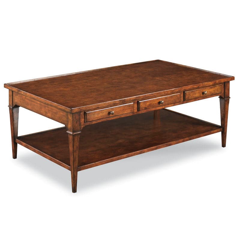 Marseille Cocktail Table, shown in medium brown and warm amber-brown with wood, metal, and three front drawers with knobs.