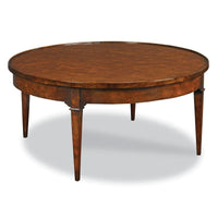 Marseille Round Cocktail Table, shown in warm medium brown and cherry amber with hardwood and cherry veneer.
