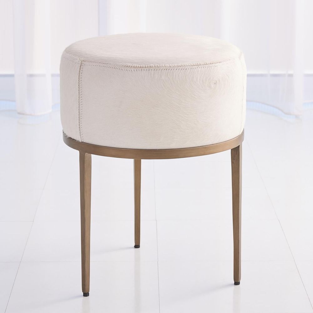 Urban Stool, shown in ivory and cream with hide, hair-on-hide, and fixed four-leg base.