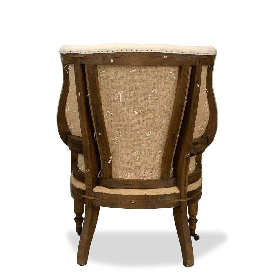 Additional view of Irish Chair in cream and ivory, featuring deep button tufting and fixed arms.