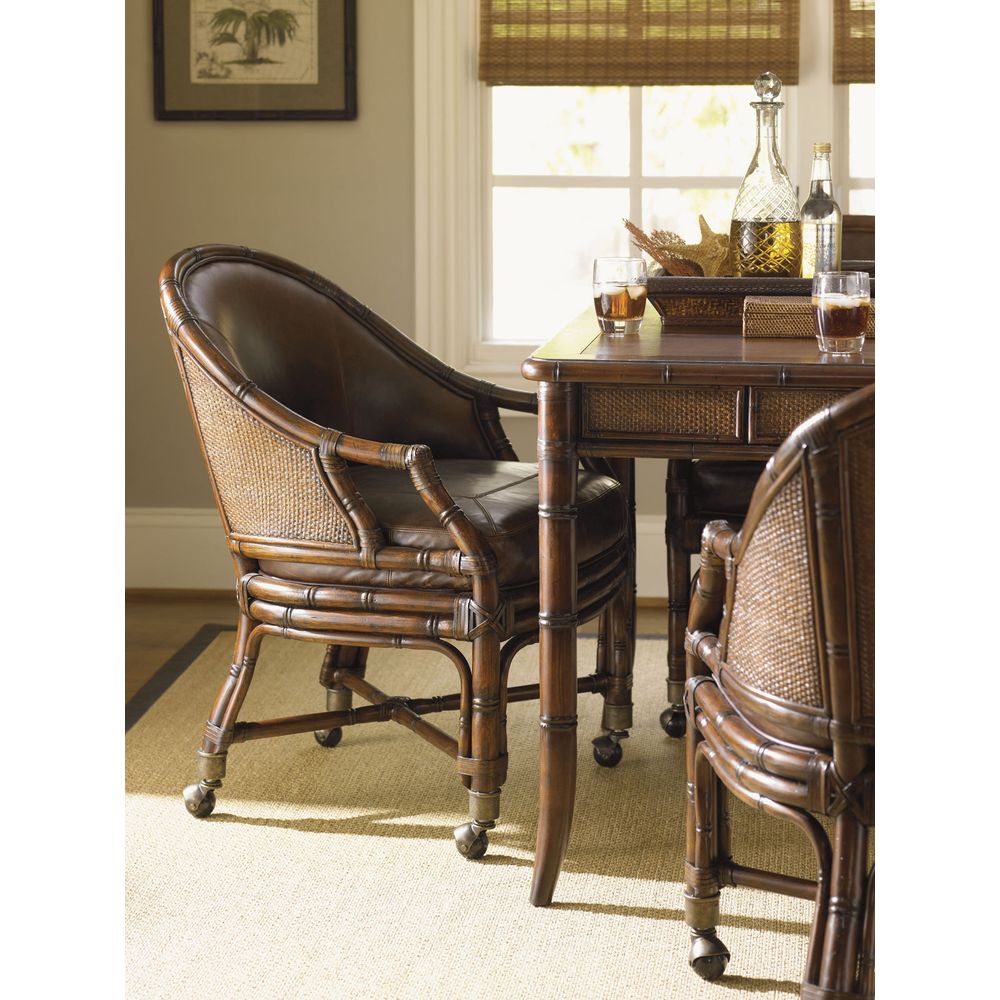 Additional view of Rum Runner Desk Chair in dark brown and sienna brown, featuring woven cane finish and casters.