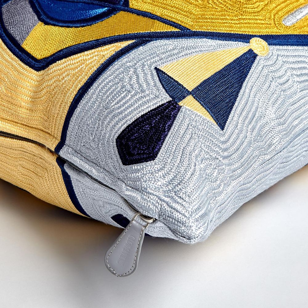 Additional view of Maya Pillow in mustard yellow and navy blue, featuring raised embroidery finish and zipper closure.