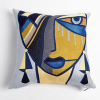 Maya Pillow, shown in mustard yellow and navy blue with embroidered textile, woven fabric ground, and zipper closure.