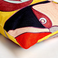 Additional view of Paloma Pillow in peach and yellow, featuring embroidered finish and removable cover with zipper closure.