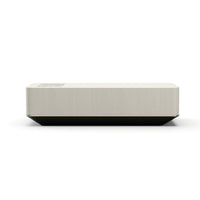 Madera Plinth Cocktail Table, shown in light beige and black with wood, metal, and integrated stone insert.