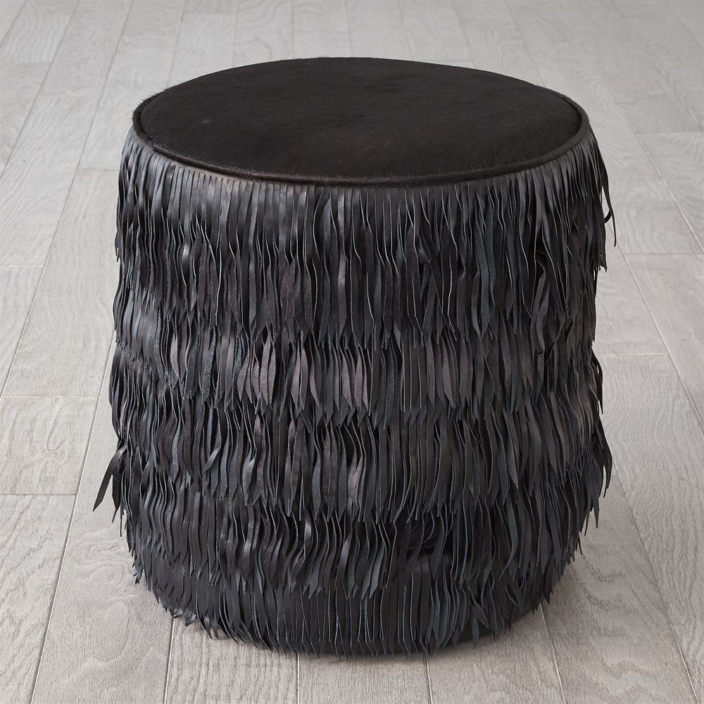 Fringe Ottoman, shown in black with hair-on-hide, leather, and a round upholstered seat top.