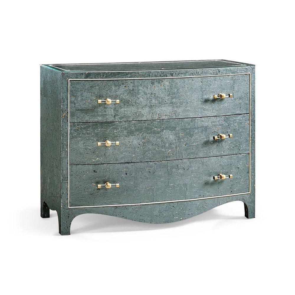 Suberin Cork Bow Front Chest, shown in muted teal-green and blue-green with cork, glass, and three full-width drawers.