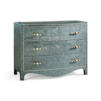 Suberin Cork Bow Front Chest, shown in muted teal-green and blue-green with cork, glass, and three full-width drawers.