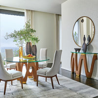 Alternate view of Wave Dining Table, featuring brushed brass caps, wood, tempered glass, and a round glass dining surface.