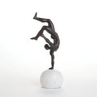 One Hand Balancing Act, shown in dark bronze and white with bronze, marble, and a spherical freestanding base.