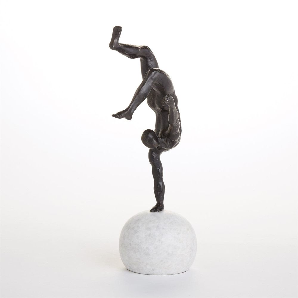 Additional view of One Hand Balancing Act in dark bronze and white, featuring honed finish and a spherical freestanding base.