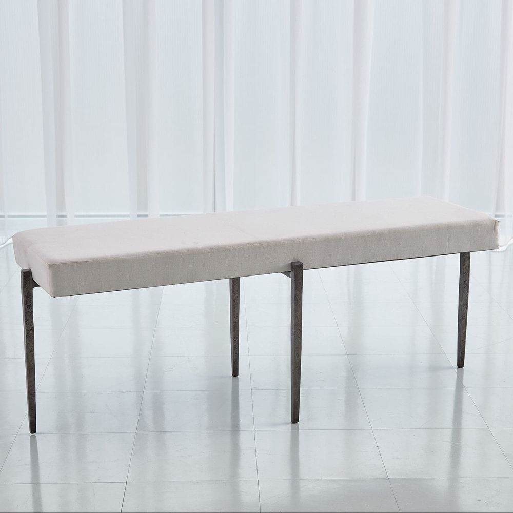 Laforge Bench, shown in cream and off-white with fabric, metal, and a backless seat.