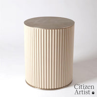 Camille Side Table, shown in cream and ivory with wood, metal, and fixed cylindrical pedestal base.