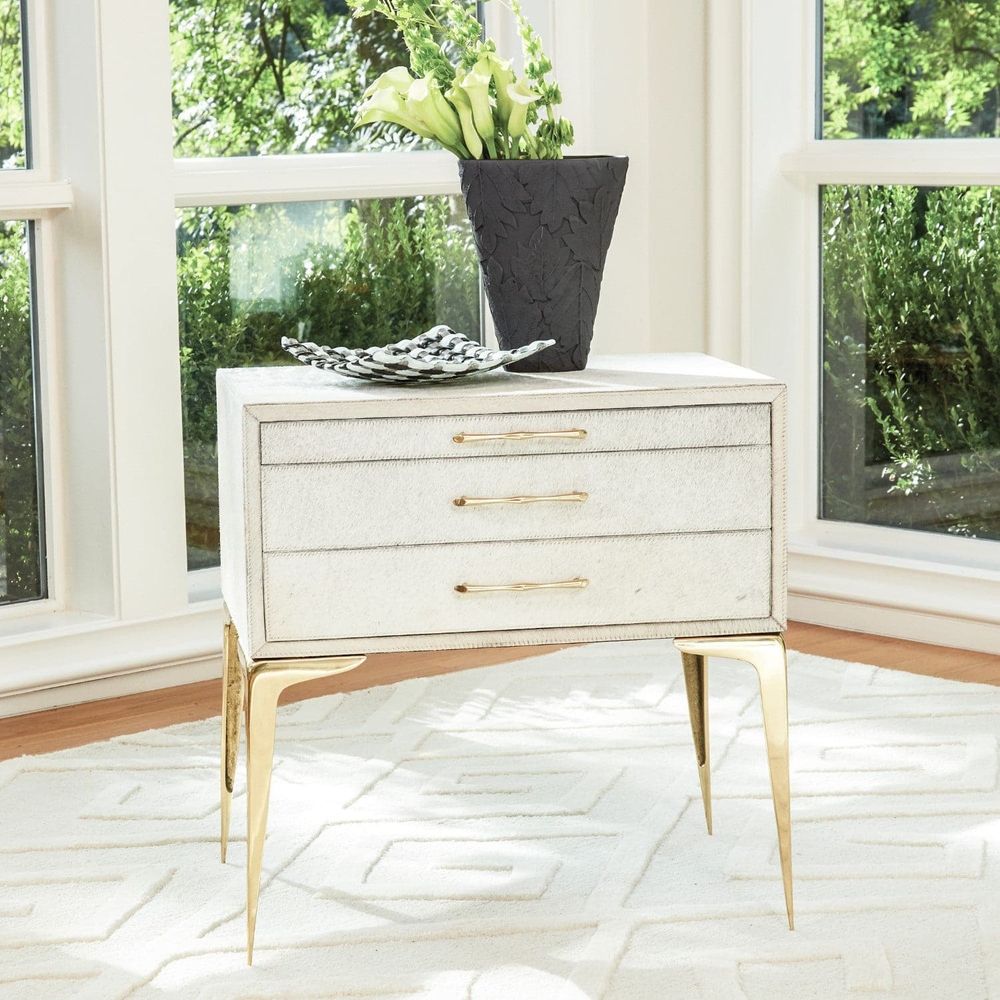 Alternate view of Stiletto Bedside Table in ivory and black with rectangular three-drawer case on splayed stiletto legs.