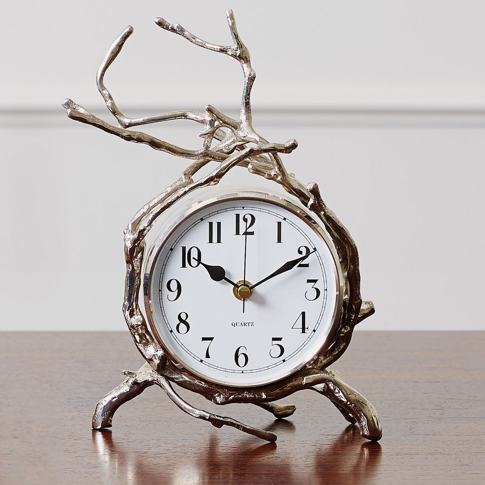 Twig Clock, shown in silver and gold with cast metal, glass, and freestanding tabletop quartz analog clock.