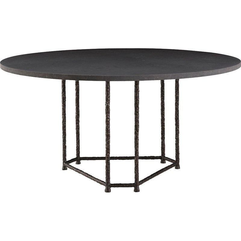 Aitne Dining Table, shown in charcoal black and dark bronze with stone, forged metal, and a round dining surface.