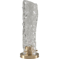 Vela Table Lamp, shown in clear and brass gold with textured glass, brass, and a circular brass base.