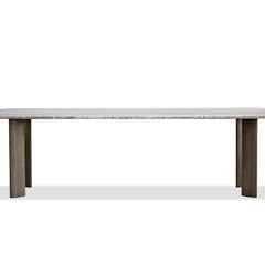 Shoku Dining Table, shown in silver-grey and warm taupe with travertine stone, ash wood, and a expansive flat dining surface.