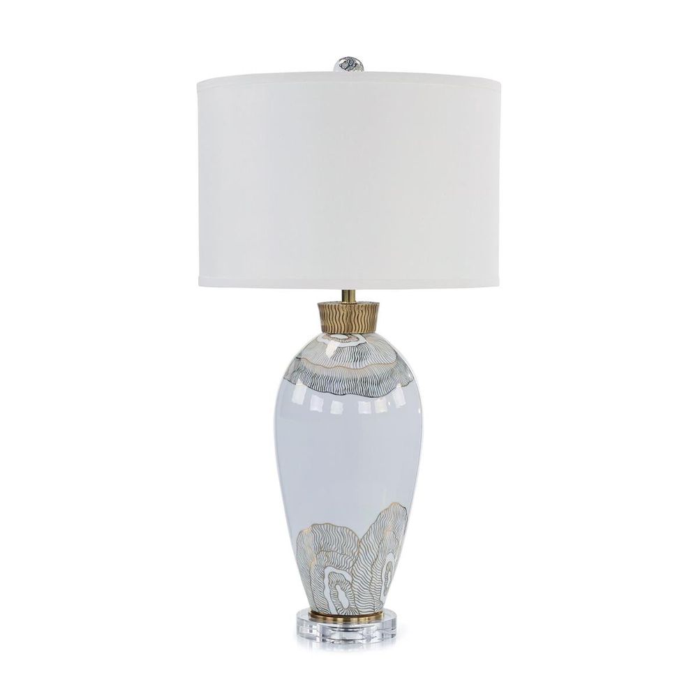Isolde Table Lamp, shown in white and ivory with porcelain, fabric, and a fabric drum shade.