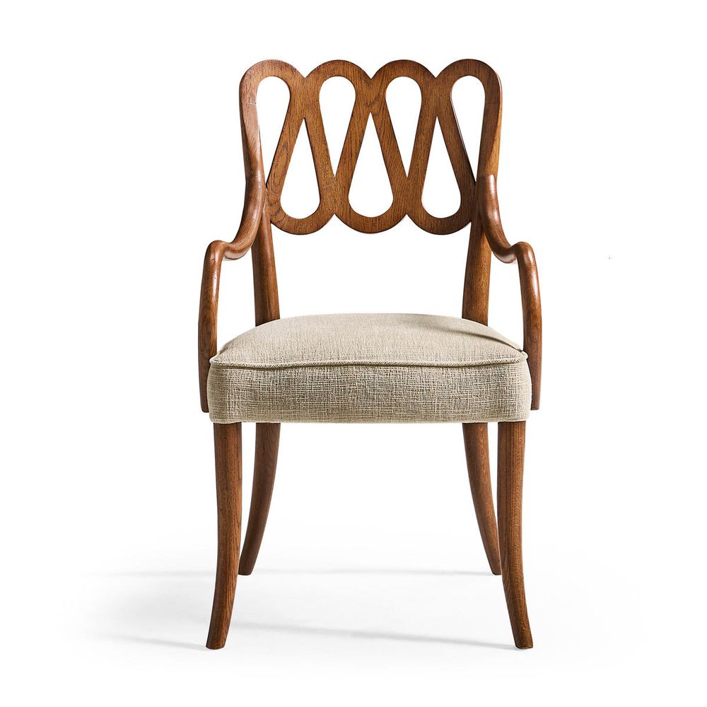 Ampney Toasted Oak Arm Chair, shown in warm medium brown and beige with oak wood, woven fabric, and fixed arms.