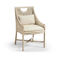 Additional view of Fjord Dining Chair, featuring matte upholstery finish, wood, cane rattan, and fixed open arms.