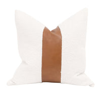 The Split Decision 20" Essential Pillow, shown in white and cognac brown with bouclé fabric and leather.