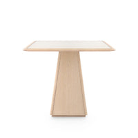 Alma Center/Dining Table, shown in light oak and natural with oak, cane, and a pedestal base.