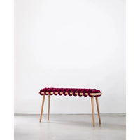 Burgundy Velvet Woven Bench, shown in burgundy and magenta with velvet, wood, and four fixed tapered legs.