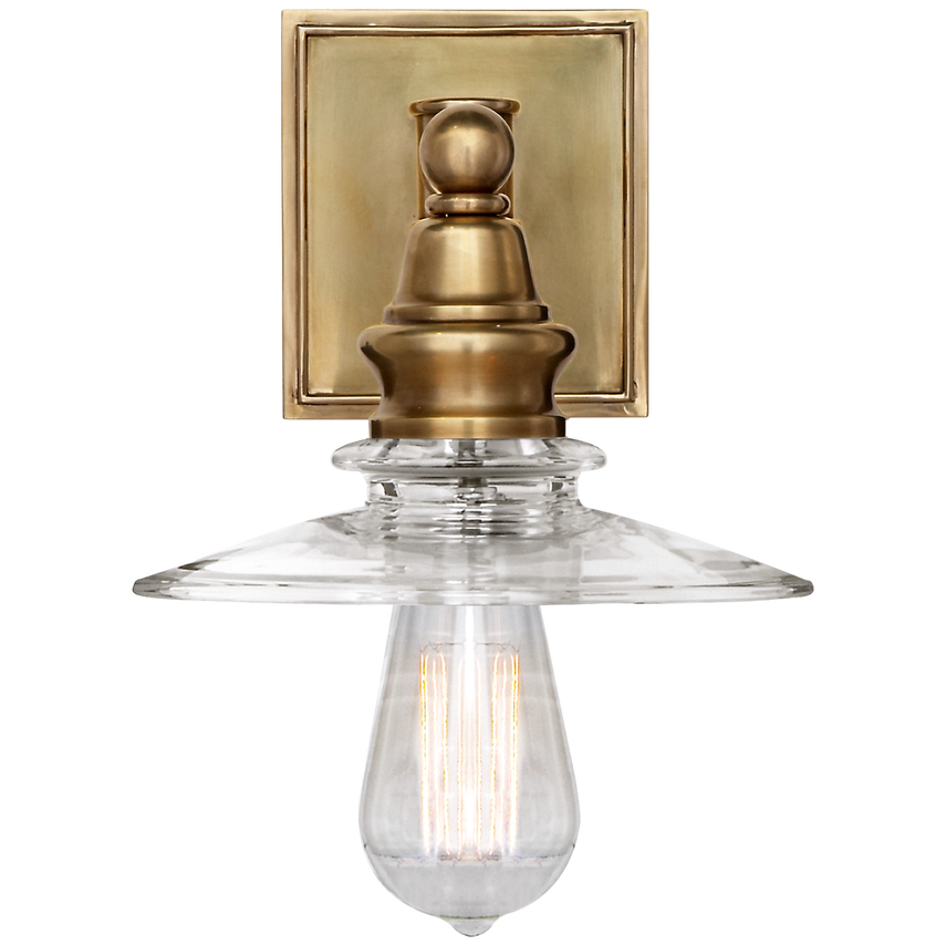 Cavelleine Shield Sconce, shown in antique brass and brushed pewter with metal, glass, and a square wall-mount backplate.