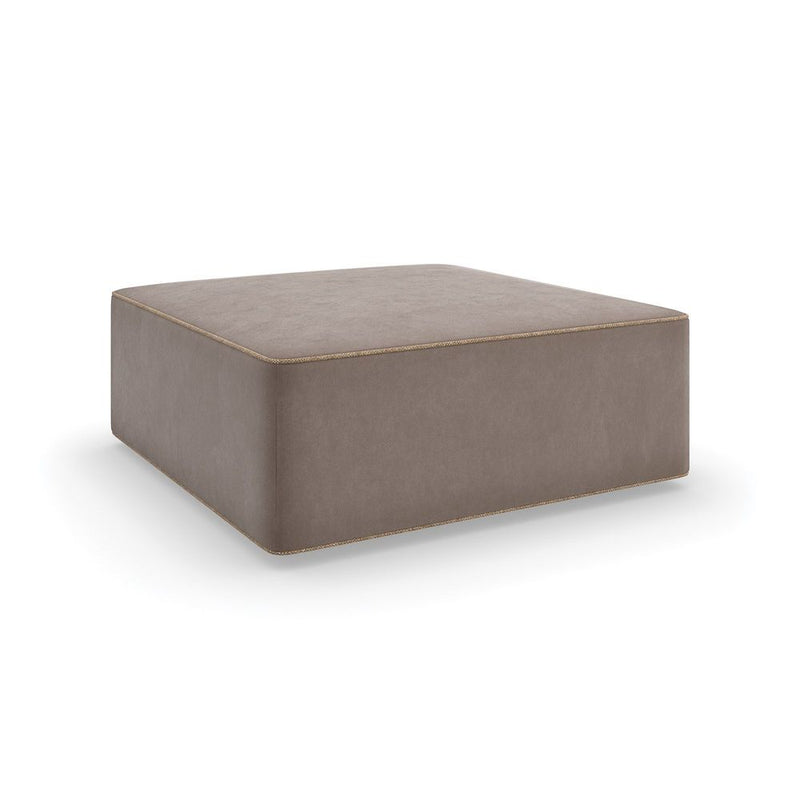 Granada Ottoman, shown in taupe and bronze with fabric, upholstery, and solid floor-hugging base without legs.